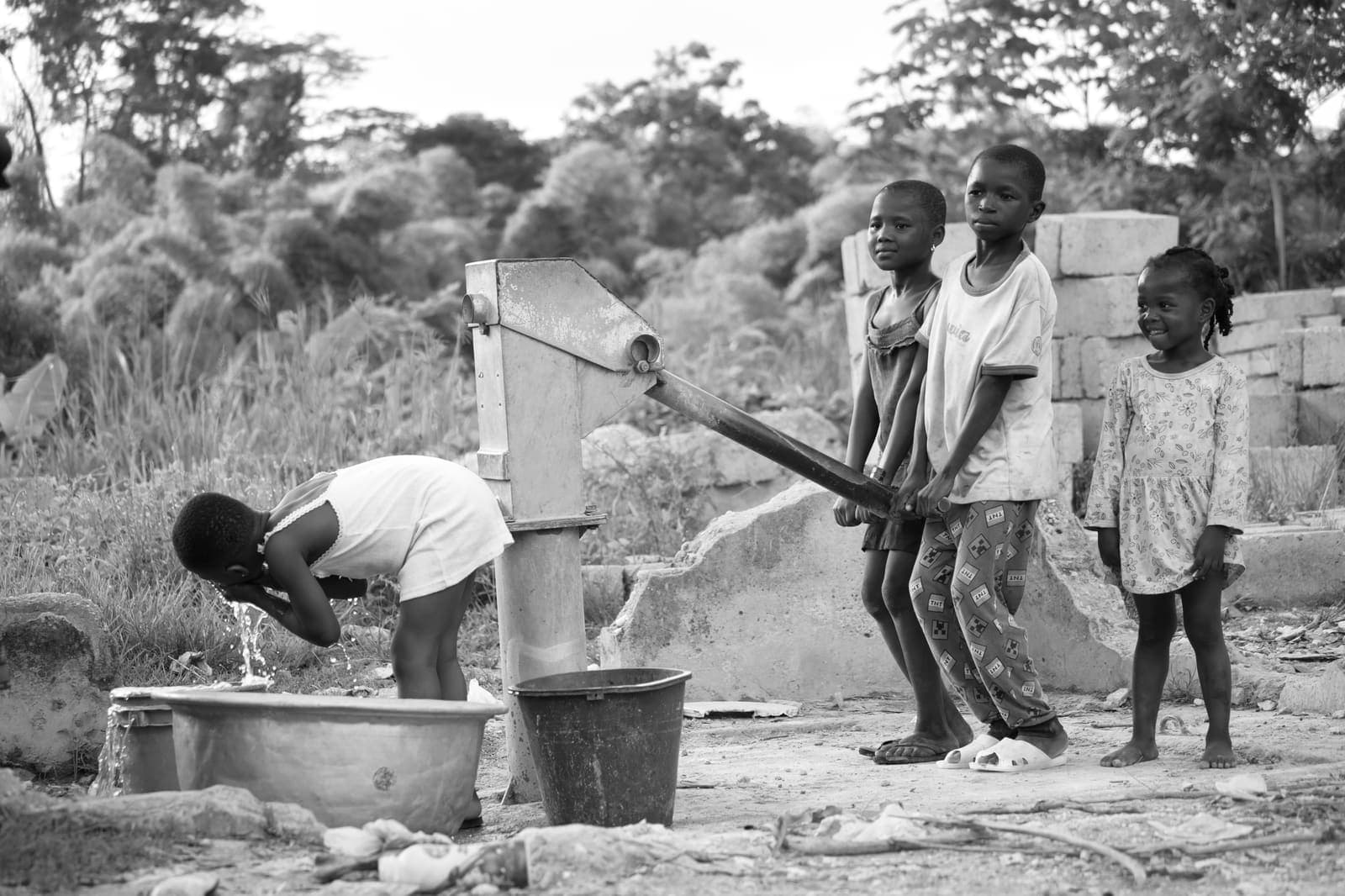 Children collecting water at a community pipe well